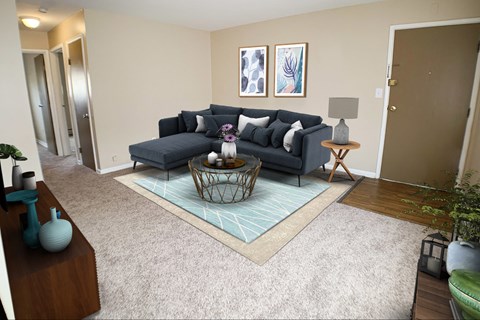 a living room with a blue couch and a rug